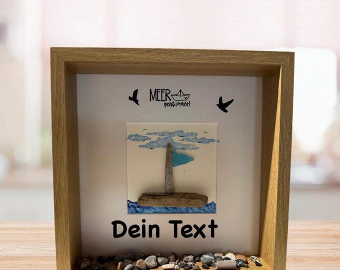 Maritime stone picture saying: The sea always goes with a North Sea sailboat made of driftwood and Baltic Sea beach finds.
