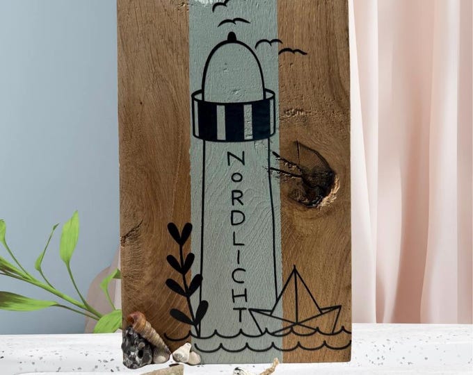 Maritime decoration. Wooden sign made of oak with a plotter-designed lighthouse motif. Decorated with North Sea flotsam and jetsam.