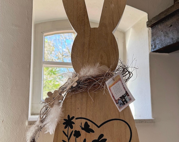 Easter bunny made of wood, decorated with a plotter, ready to stand. Beautiful Easter decoration.