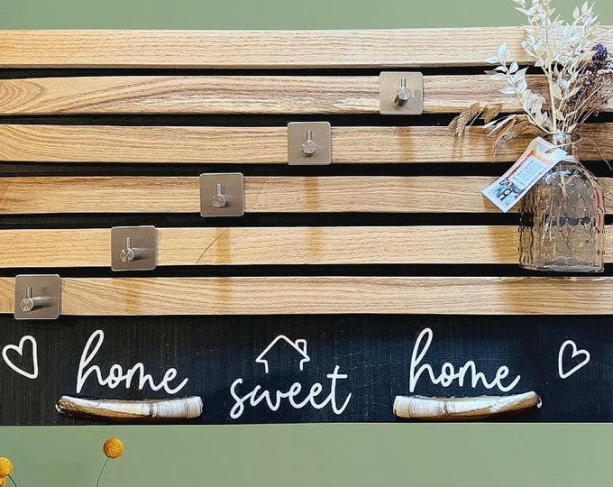 Modern decorative wall panels as a key rack featuring Baltic and North Sea shells. Home Sweet Home plotter lettering.