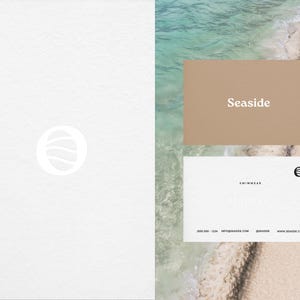 May include: A white business card with the text "Seaside Swimwear" and a logo of a circle with a wave inside. The card also includes contact information: 000-000-1234, info@seaside.com, @seaside, www.seaside.com.
