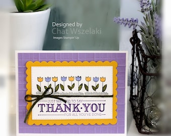 May include: A rectangular greeting card with a light purple grid-textured background, a yellow scalloped border, and a white centre panel featuring a row of illustrated tulips and the text: JUST WANTED TO SAY THANK YOU FOR ALL YOU'VE DONE.