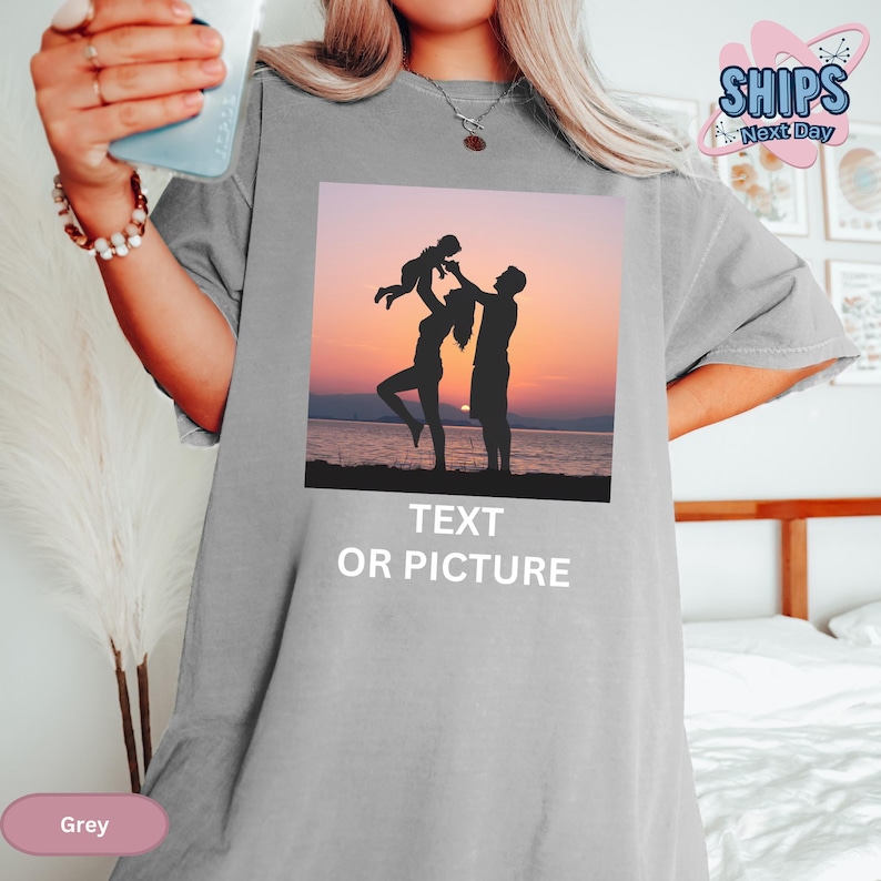 a woman holding a cup of coffee while standing next to a bed