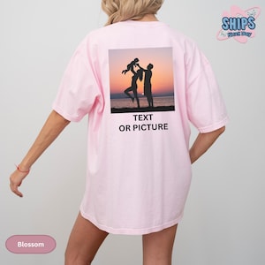 a woman wearing a pink shirt with a picture of two people on it