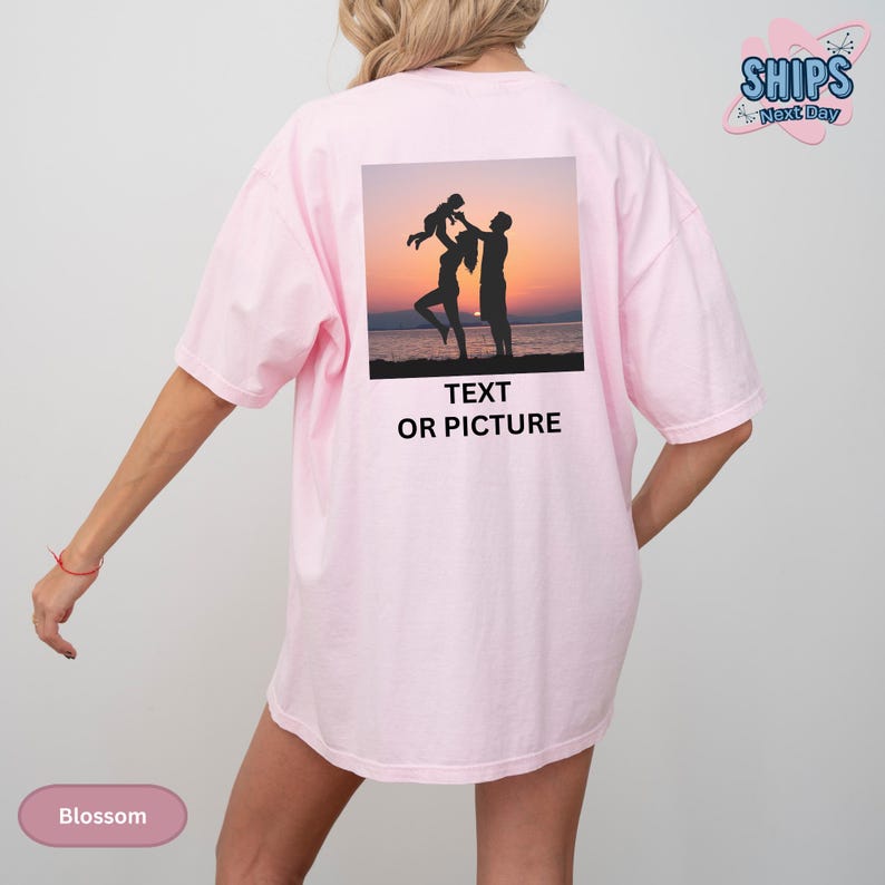 a woman wearing a pink shirt with a picture of two people on it