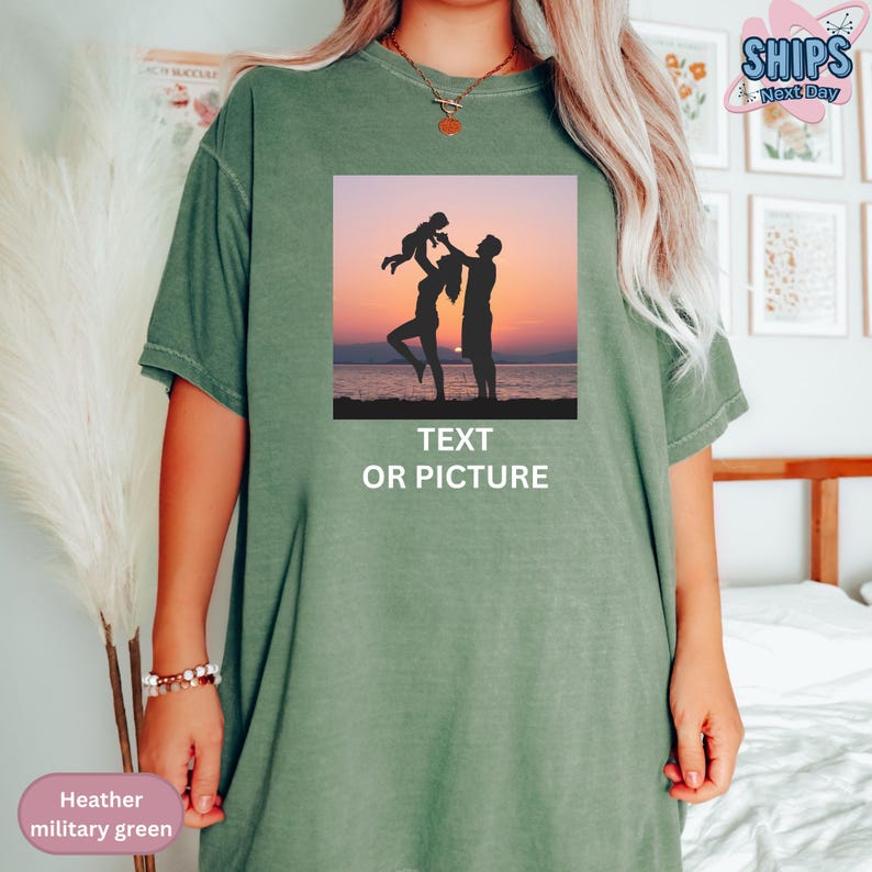 a woman wearing a green t - shirt with a picture of a man and woman