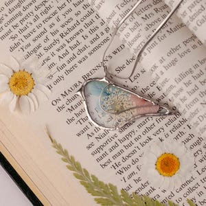 Handmade bird-shaped pendant featuring real pressed flowers.