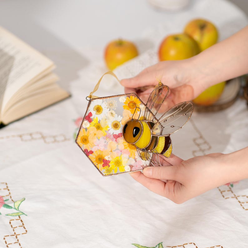 bee stained glass decor with real flowers inside honeycomb shape