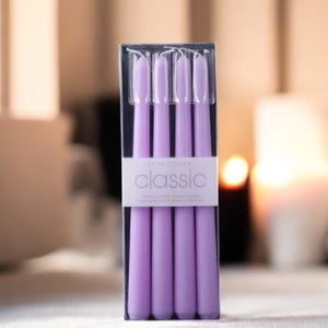 May include: A package of four lavender taper candles, labeled "Classic" with the brand name "Glow Candle".