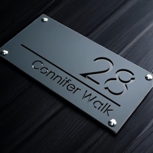 May include: A gray acrylic house number sign with the number 28 and the text "Conifer Walk" in a modern font.