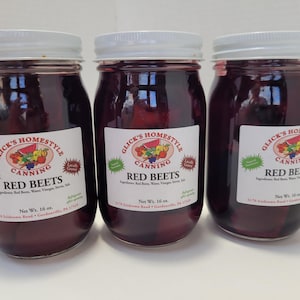 May include: Three glass jars of red beet relish with white lids. Each jar has a label that reads "Glick's Homestyle Canning Red Beets" with a net weight of 16 ounces.