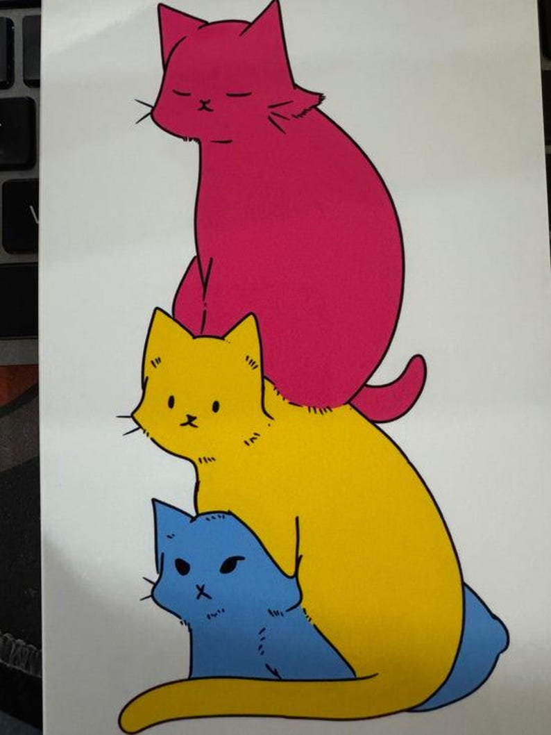 May include: A vertical illustration featuring three stacked cats. The top cat is bright pink with closed eyes, the middle cat is yellow with wide eyes, and the bottom cat is light blue with narrow eyes. All cats have black outlines.