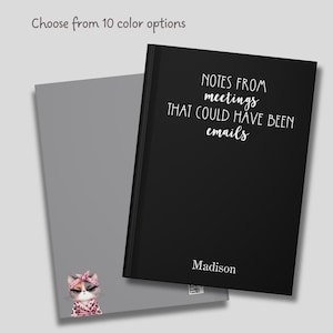 May include: Black notebook with the text "NOTES FROM meetings THAT COULD HAVE BEEN emails" and the name "Madison" printed in white. The notebook is open to reveal a gray page with a cartoon illustration of a cat wearing a pink bandana.