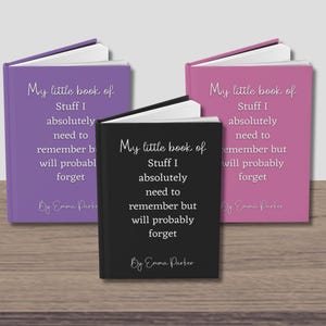 May include: Three small, hardcover journals with the title "My little book of Stuff I absolutely need to remember but will probably forget" on the front cover. The journals are in purple, black, and pink.
