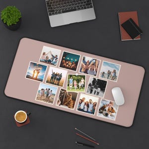 May include: A rectangular, blush-colored desk mat with a black border. The mat features a collection of small square photographs depicting various people and pets. A laptop, mouse, and other office supplies are also visible.