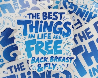 May include: A sticker with the text "THE BEST THINGS IN LIFE ARE FREE" in blue and white. The phrase "BACK, BREAST & FLY" is below the main text. The sticker has a white border and is surrounded by other stickers.