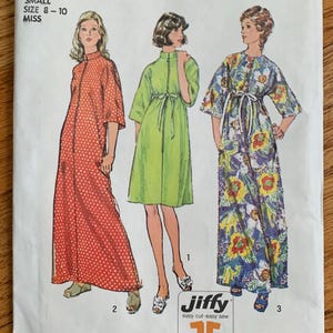 May include: Simplicity sewing pattern number 6048 for a dress. The pattern is for sizes 8-10 and includes three different dress styles: a red polka dot dress, a green dress, and a floral print dress. The pattern is labeled "Jiffy easy cut easy sew" and includes 2 or 3 main pattern pieces.