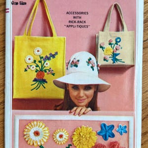May include: Vintage Simplicity pattern cover featuring a woman wearing a white hat with floral embellishments. The cover showcases two tote bags and a hat with floral appliques. The text reads "Accessories with Rick-Rack 'Appli-Tiques'" and "One Size".