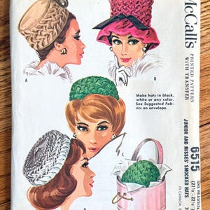 May include: Vintage McCall's sewing pattern for junior and misses' smocked hats. The pattern envelope features illustrations of four different hat designs in various colors, including a pink hat with a black brim and a green hat.