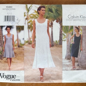 May include: A Calvin Klein Vogue American Designer sewing pattern envelope, number 1590, featuring three variations of a sleeveless dress. The images show a white midi-length dress, a grey knee-length dress, and a black knee-length dress.