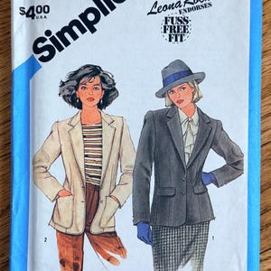May include: Simplicity sewing pattern featuring illustrations of two women in blazers. The pattern includes the text "Leona Rocha Endorses FUSS-FREE FIT" and the price "$4.00 U.S.A.". The pattern number is 6493.