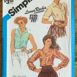 May include: Simplicity sewing pattern number 6520, featuring three different blouse designs. The pattern is endorsed by Leona Rocha and includes a special chart on how to work with plaids. The pattern is for size 14, miss.
