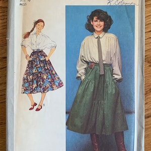 May include: Simplicity sewing pattern number 8680 for a skirt. The pattern includes two different skirt styles, one with a floral print and the other a solid green. The pattern is for size 10 miss.