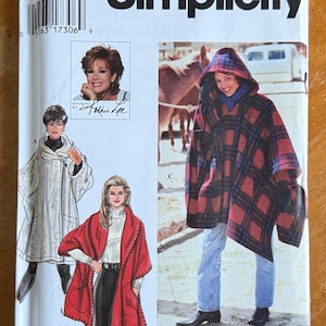 May include: A Simplicity sewing pattern envelope, number 9122, featuring designs by Kathie Lee. The front displays illustrations of three different hooded capes or ponchos, including a red and black plaid hooded version, with the text easy to sew.