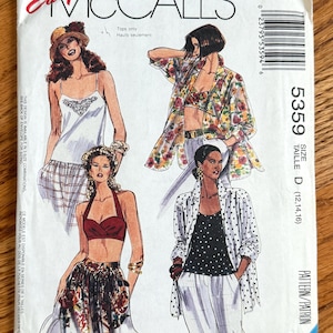 May include: A McCall's sewing pattern envelope 5359 for tops, size D (12, 14, 16). The front features illustrations of four different top styles, including a camisole, a floral print shirt, a halter top, and a polka dot shirt, with text labels.