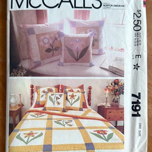 May include: McCall's sewing pattern featuring floral designs for pillows and a quilt. The pattern includes images of the finished products, showcasing a bed with matching pillows and a close-up of the pillow designs. The pattern number is 7191.