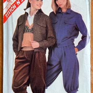 May include: A vintage sewing pattern cover featuring two models wearing outfits. One model wears a brown jacket, sweater, and pants. The other model wears a blue jacket and pants. The cover has the text "STITCH 'N SAVE" and "SIZE B (12-14-16)".
