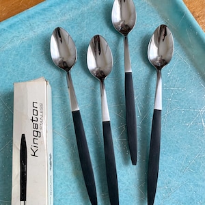 May include: Four silver spoons with black handles on a blue tray. The spoons are labeled "Kingston Stainless".