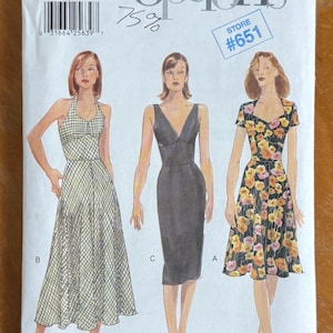 May include: A Vogue Easy Options sewing pattern envelope 9668 for sizes 6-8-10. The front displays three dress variations: a white and green gingham halter dress, a solid black sleeveless sheath dress, and a black dress with a yellow floral print.