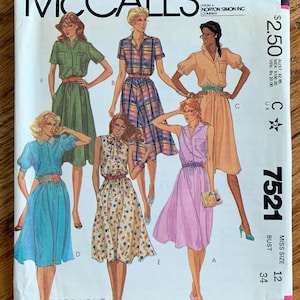 May include: A vintage McCall's sewing pattern featuring illustrations of dresses. The pattern cover displays various dress designs in different colors and patterns, including a green dress, a plaid dress, and a pink dress. The pattern number is 7521, and the bust size is 34 inches.
