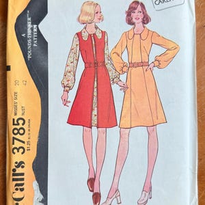 May include: Vintage McCall's 3785 sewing pattern for Misses' dress and sleeveless coat. The pattern cover features illustrations of two dresses, one red with floral sleeves and the other yellow, both with belts. The pattern size is 20 and 42.