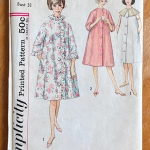 May include: Vintage Simplicity pattern 4708 featuring illustrations of three different robes. The first robe is floral with ruffles, the second is solid pink, and the third is white with a decorative collar. The pattern size is 10, with a bust size of 31 inches.