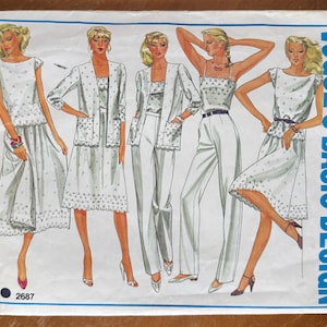 May include: A Vogue's Basic Design sewing pattern envelope, number 2687, featuring illustrations of five outfits in white with small floral patterns, including skirts, jackets, trousers, and tops, displayed on a white background with blue borders.