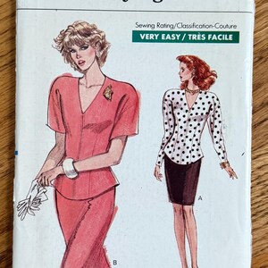 May include: A Very Easy Very Vogue sewing pattern envelope, number 7240, for sizes 8-10-12. The front displays illustrations of two outfits: a solid coral short-sleeved top with a matching skirt, and a white long-sleeved top with black polka dots.