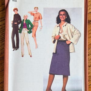 May include: Simplicity sewing pattern 9276 for Misses' size 14. The pattern features illustrations of a jacket, skirt, and pants ensemble. The cover has a brown border and the text "Top and camisole not included".