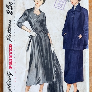 May include: Vintage Simplicity printed sewing pattern featuring two elegant dress designs. The pattern includes size 14 with a 32-inch bust. The cover art showcases illustrations of the finished garments, with the text "Simplicity is America's Fashion."