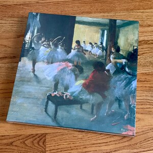 May include: A painting of a ballet class in a studio. The dancers are wearing white tutus and are in various poses. The room is lit by a large window and there are several chairs and a bench in the background.
