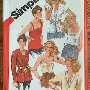May include: Vintage Simplicity sewing pattern envelope featuring fashion illustrations. The cover displays various women's outfits, including tops, skirts, and jackets. The text "Simplicity" is prominently displayed, along with the size and style number.