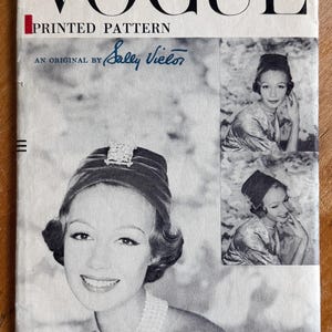 May include: Vintage Vogue Printed Pattern cover featuring a woman wearing a hat and pearl necklace. The cover includes the text "VOGUE PRINTED PATTERN" and "AN ORIGINAL BY Sally Vielor". The cover is from 1956 and has a head size of 22.