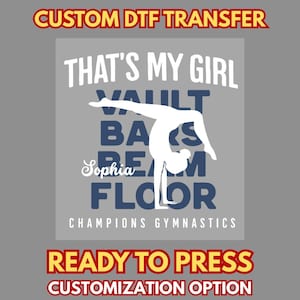 May include: A gray DTF transfer design with the text "THAT'S MY GIRL" and the words "VAULT, BARS, BEAM, FLOOR" in blue. A white gymnast silhouette is in the center. The text "Sophia" is in cursive. The words "CHAMPIONS GYMNASTICS" are at the bottom.