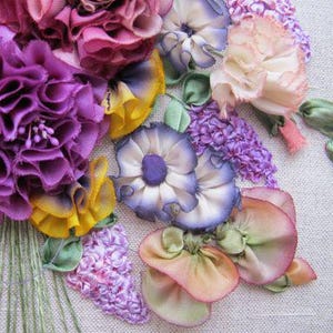 May include: A close-up of a colorful silk ribbon embroidery bouquet. The bouquet features purple, pink, yellow, and white flowers with green leaves. The flowers are made of silk ribbon and are arranged in a realistic style.