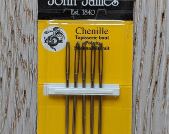 May include: A pack of 5 John James Chenille tapestry needles, size 16, in a yellow and white packet. The packet says "Finest Quality Needles".