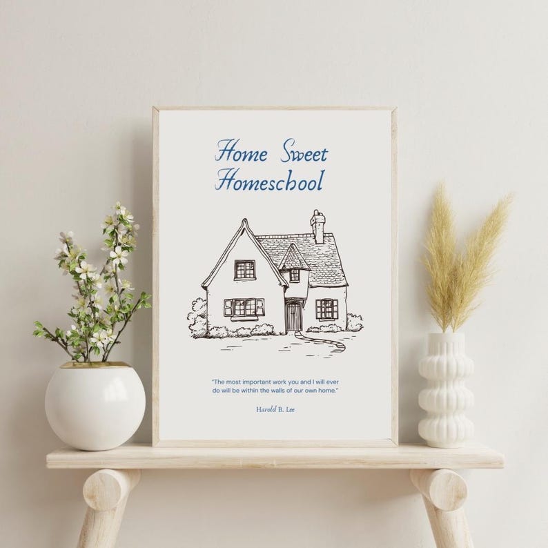 May include: A framed print with the text "Home Sweet Homeschool" above a detailed sketch of a house. Below the house is a quote by Harold B. Lee. The print is displayed on a wooden shelf with decorative plants.