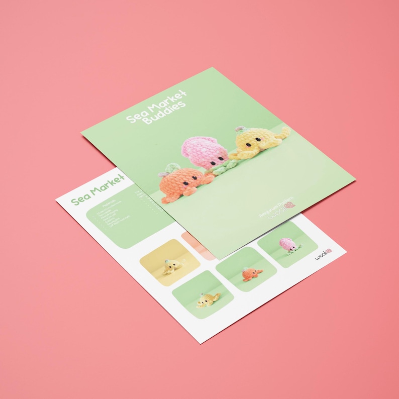 May include: Two green brochures with the text "Sea Market Buddies" and "Sea Market" on a pink background. The top brochure features three crocheted octopus toys in orange, pink, and yellow. The bottom brochure has images of the octopus toys.