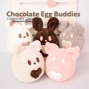 May include: Five crocheted stuffed animals shaped like an egg. The animals are a bunny, a pig, a bear, a cat, and a mouse. The animals are all brown, pink, white, and gray. The animals are all wearing a heart on their chest. The animals are all made of yarn. The animals are all sitting on a wooden surface. Chocolate Egg Buddies Valentine's Collection Amigurumi Pattern.