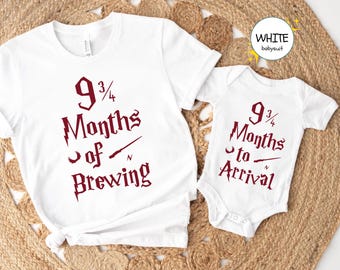 May include: White t-shirt and onesie set with a Harry Potter themed design. The t-shirt says "9 3/4 Months of Brewing" and the onesie says "9 3/4 Months to Arrival".